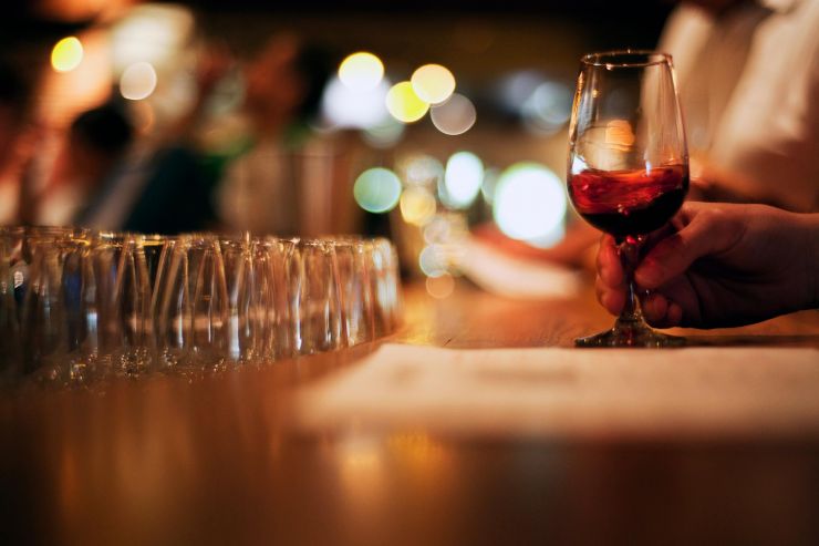 Close up of bar and women's hand holding drink